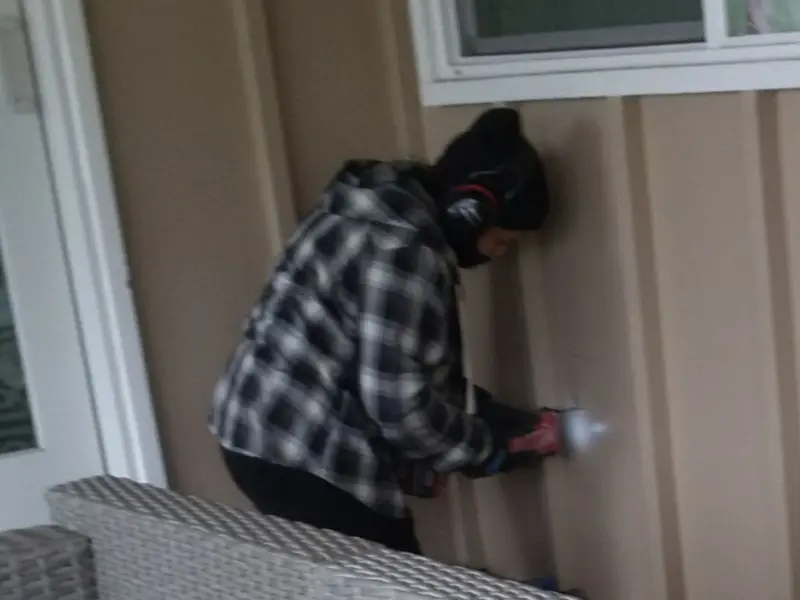 Professional electrician installing an exterior outlet in Kingstowne